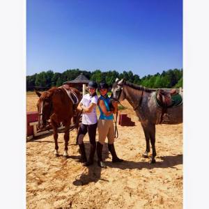 Kinsey Peterson and Haley Steffans pose with their horses at the Furman Equestrian Team stables. Photo courtesy of Furman Equestrian Team