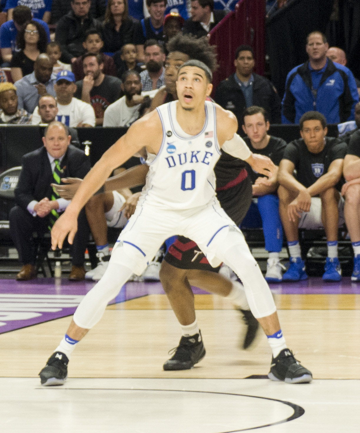 Jayson Tatum boxes out for a rebound.